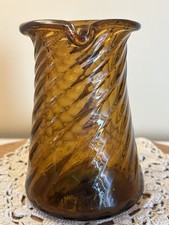 VINTAGE HAND BLOWN AMBER GLASS PITCHER WITH TWISTED SWIRL. Almost 5” Tall. picture