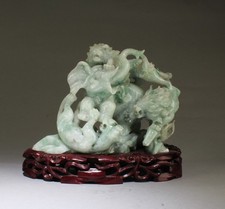 A Chinese Carved Jade Figurine. Comes fitted with a wooden stand picture
