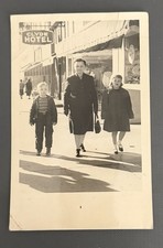 1950s Family Walking In A Town Center Passing The Clyde Hotel Photo Post Card picture