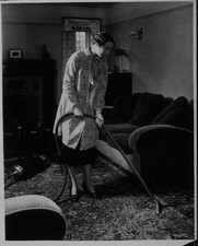 Housewife cleaning a sitting room with an electrical vacuum cleaner Old Photo picture
