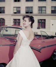 Woman modelling women's fashions smiling as she looks over shoulde- Old Photo picture
