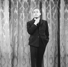US comedian entertainer Jack Benny adjusts his tie as he stands in- Old Photo picture