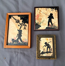 3 silhouettes.  wood framed.  Milkweed/wildflower backdrop. Kids in nature picture