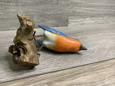 Wooden Carved Bird Resting On Wood picture