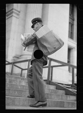 1930s Postal Worker Uniform Man Carrying Mail Parcel on Building Stairs picture