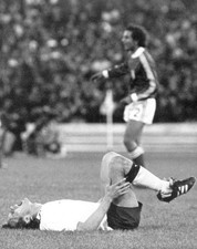 The fouled German midfielder Heinz Flohe lies ground a face contor- Old Photo picture