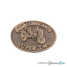 Vintage Farmland Ind John Deere Tractor Lubricant Oval Brass Belt Buckle picture