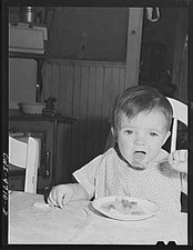 1900s Toddler Eating at Table Vintage Black and White Family Snapshot picture