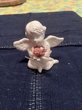 Angel Figurine / Sitting, holding flowers. Pre-owned picture