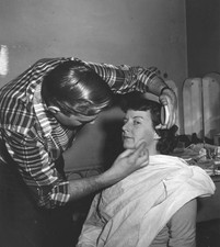 The unnamed host of an ABC television show sits a chair as makeup - Old Photo picture