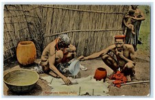 c1910 Tribe Wood House Native Men Braying A Skin Unposted Antique Postcard picture