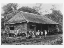 About A Dozen People Standing In Front Of A Thatched Dwelling In  - Old Photo picture