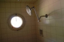 View of a vintage shower head in a tiled shower stall ca1960s Old Photo picture