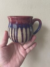 A Pretty Colorful Mug With Artist Signature On It picture