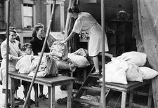 Women who have been bombed out of their homes receiving their clea- Old Photo picture