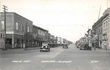 H24/ Gladstone Michigan RPPC Postcard c1940s East Drug Store Autos 15 picture