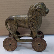 AC Williams cast iron lion coin bank on wheels 1920s picture
