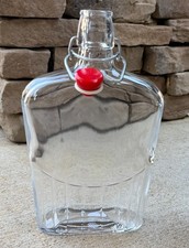 large swing top glass bottle with red top wide with ribbed bottom unique picture