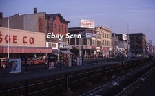 Original 35mm Slide Passaic NJ Street Scene Stores Signs Cars Train Tracks  1963 picture