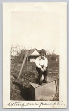 1920s Cute Boy Flat Cap Sitting on Pumpkin near Rural Farmhouse Antique Photo picture