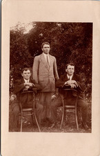 Postcard Men Sitting Reverse on Chairs outside Brothers? Real Photo RPPC 1914 picture