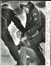 1984 Press Photo Police officers subdue resident Jim Webb at Port of Kenai, AK picture