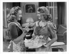 Joan Blondell showing ticket to Lana Turner standing near a scene - Old Photo picture