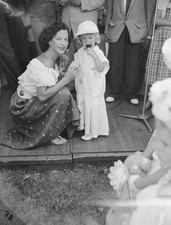 Austrian-born American actress Hedy Lamarr kneels down attends to - Old Photo picture