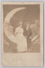 Portrait of Couple Sitting on Anthropomorphic Paper Moon RPPC UNP Postcard picture