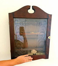 vintage wooden wall-mounted tobacco pipe display cabinet with a frosted or etche picture
