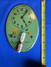 1930's era kitchen egg timer or baking timer on cardboard wall hanger picture