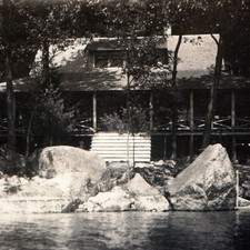 c1910s Lakeside Cabin Lodge Porch US Flag Boulders Lake RPPC Cyko Postcard Photo picture