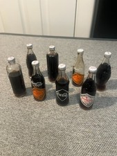 8 Miniature Coca Cola Bottles Depicting Different Eras of Coke Bottles picture