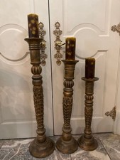 Three wooden carved floor-standing candle holders picture
