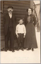 Vintage 1910s Real Photo RPPC Postcard Family Posing Next To House in the Snow picture