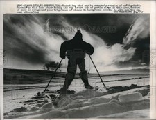 1961 Press Photo Lone Skier resembles Abominable Snowman texture of snow clouds picture