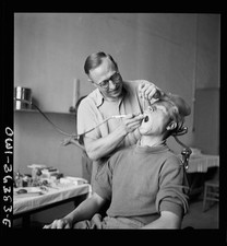 Photo:1930s Dentist Treating Male Patient Dental Office Surgery picture