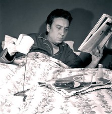 Italian writer Luciano Bianciardi reading a newspaper lying bed Bi- Old Photo picture