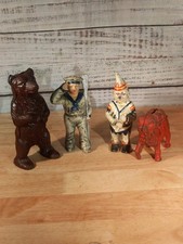 Lot Of 4 Cast Iron Coin Banks picture