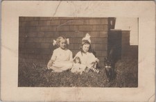 Two girls posed outdoors RPPC Doll and Cat Antique Postcard picture