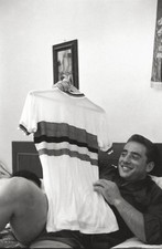 The Italian cyclist Sante Gaiardoni showing a jersey while lying a- Old Photo picture