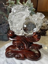 Clear quartz fish with ball lotus flower carving on custom wood stand picture