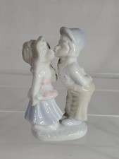 Vintage Porcelain Girl and Boy Kissing on the Cheek Holding Presents  picture