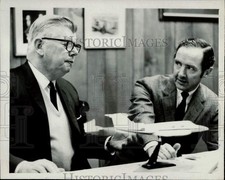 1969 Press Photo Bill Lear and illustrator Don Moss inspect a airplane model picture