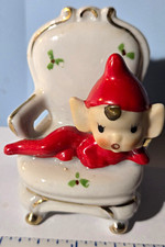 Vintage Ceramic Elf Figurine Reclining in White Chair, Red Hat and Suit  picture