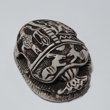 Ancient Egyptian scarab stone carving, black and white, hieroglyphic details picture