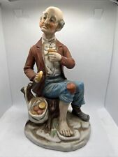 Vintage Porcelain figurine Of a Old sad Poor man eating some veggies, One shoe picture