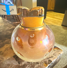 Pink glass orb table lighter with metal top, round spherical body picture