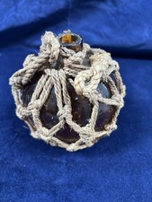 Amber glass fishing float — vintage French buoy in rope net picture