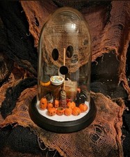A handmade miniature Halloween diorama inside a glass cloche dome picture